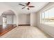 Bright living room with large window, ceiling fan and beautiful flooring throughout at 1245 W Lobo Ave, Mesa, AZ 85202