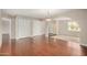 Hardwood floors, an elegant light fixture and 2 large closets make this living room a great hangout at 1245 W Lobo Ave, Mesa, AZ 85202
