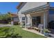 Inviting backyard patio with outdoor seating, artificial grass, and lush landscaping at 1320 N Brittany Ln, Gilbert, AZ 85233