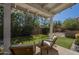Backyard featuring artificial turf, covered patio, and lush greenery at 1320 N Brittany Ln, Gilbert, AZ 85233