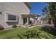 Home exterior view showcasing the backyard with covered patio and artificial turf at 1320 N Brittany Ln, Gilbert, AZ 85233