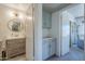 Bright bathroom features a modern vanity, elegant round mirror, and stylish decor at 1320 N Brittany Ln, Gilbert, AZ 85233