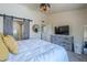 Comfortable bedroom featuring a gray dresser with tv, and a modern light fixture at 1320 N Brittany Ln, Gilbert, AZ 85233
