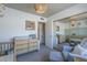 Comfortable Bedroom with a crib, changing table, and a cozy armchair at 1320 N Brittany Ln, Gilbert, AZ 85233