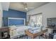 Bedroom features wood floors, ceiling fan, an office, a queen bed, and natural light at 1320 N Brittany Ln, Gilbert, AZ 85233