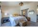 Well-lit bedroom with a white bed, rustic bedside table, and stylish wicker baskets at 1320 N Brittany Ln, Gilbert, AZ 85233