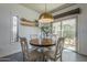 Dining area featuring stylish pendant lighting and sliding glass doors to the backyard at 1320 N Brittany Ln, Gilbert, AZ 85233