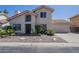 Charming two-story home with a desert landscaped front yard, tile roof and two car garage at 1320 N Brittany Ln, Gilbert, AZ 85233