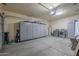 Spacious garage with ample storage, washer/dryer, and epoxy flooring at 1320 N Brittany Ln, Gilbert, AZ 85233