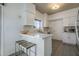 Bright kitchen with white cabinets, stylish backsplash, and a functional breakfast bar at 1320 N Brittany Ln, Gilbert, AZ 85233