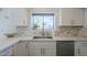 This kitchen boasts marble backsplash, stainless steel appliances, and quartz countertops at 1320 N Brittany Ln, Gilbert, AZ 85233