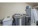 Convenient laundry area with modern washer and dryer units and utility sink at 1320 N Brittany Ln, Gilbert, AZ 85233
