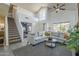 Bright living room featuring vaulted ceilings, large windows, and a staircase at 1320 N Brittany Ln, Gilbert, AZ 85233