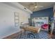 Stylish home office boasts wood floors, a ceiling fan, and views of the neighborhood at 1320 N Brittany Ln, Gilbert, AZ 85233