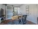 Home office with wood floors, sliding barn door, neighborhood views, and stylish desk at 1320 N Brittany Ln, Gilbert, AZ 85233