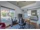 This bright office has wood floors, a ceiling fan, a large window and a sliding barn door at 1320 N Brittany Ln, Gilbert, AZ 85233