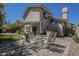 A brick patio with a table and chairs offers a relaxing outdoor space with a home's stucco exterior in the background at 1320 N Brittany Ln, Gilbert, AZ 85233