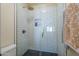 Modern shower featuring subway tile walls, a glass door, and a rainfall shower head at 1320 N Brittany Ln, Gilbert, AZ 85233