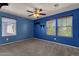 Blue bedroom with neutral carpet and multiple windows offering natural light at 13722 N 150Th Ln, Surprise, AZ 85379