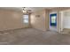 Spacious bedroom with large window, ceiling fan, and view into the bathroom at 13722 N 150Th Ln, Surprise, AZ 85379