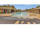 Lovely community pool area with a fountain, sun loungers, and a nearby building at 13722 N 150Th Ln, Surprise, AZ 85379