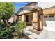 Inviting front porch with stone accents on the columns and well-maintained landscaping around the entrance at 13722 N 150Th Ln, Surprise, AZ 85379