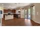 Bright kitchen with an island, a sliding door to the backyard, and wood cabinets at 13722 N 150Th Ln, Surprise, AZ 85379