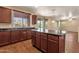 Spacious kitchen featuring an island, ample counter space, wood cabinets and views to the backyard at 13722 N 150Th Ln, Surprise, AZ 85379