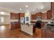 Functional kitchen featuring an island, stainless steel refrigerator, ample cabinetry, and granite countertops at 13722 N 150Th Ln, Surprise, AZ 85379