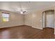 Spacious living room with hardwood floors, neutral walls, and ceiling fan at 13722 N 150Th Ln, Surprise, AZ 85379
