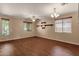 Bright living room featuring wood floors, neutral walls, shelving and plentiful windows at 13722 N 150Th Ln, Surprise, AZ 85379