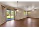 Bright living room featuring wood floors, neutral walls, and sliding glass doors to the backyard at 13722 N 150Th Ln, Surprise, AZ 85379