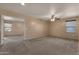 Spacious living area with neutral carpet, and natural light from a large window at 13722 N 150Th Ln, Surprise, AZ 85379