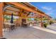 Relaxing outdoor covered patio area with ample seating, a fireplace, and a peaceful ambiance for residents to enjoy at 13722 N 150Th Ln, Surprise, AZ 85379