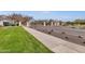 Welcoming entrance to Marley Park with manicured lawns and mature trees lining the street at 13722 N 150Th Ln, Surprise, AZ 85379