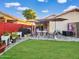 Well-kept backyard, features a patio, and green lawn at 14211 N 149Th Dr, Surprise, AZ 85379