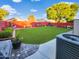 Expansive backyard with lush green lawn, vibrant landscaping, and inviting space for outdoor activities and relaxation at 14211 N 149Th Dr, Surprise, AZ 85379