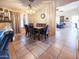 Inviting dining area with a stylish light fixture, a marble table, and seating for six guests at 14211 N 149Th Dr, Surprise, AZ 85379
