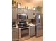 Well-equipped kitchen features gray cabinets, stainless steel appliances, and ample countertop space at 14211 N 149Th Dr, Surprise, AZ 85379