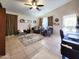 Spacious living room with tile floors, ceiling fan, comfy seating, and stylish decor at 14211 N 149Th Dr, Surprise, AZ 85379