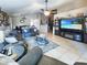 Cozy living room featuring tile flooring, ceiling fan, and relaxing seating arrangements at 14211 N 149Th Dr, Surprise, AZ 85379