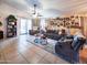 Open-concept living room with tile flooring, ceiling fan, and comfortable seating for entertaining at 14211 N 149Th Dr, Surprise, AZ 85379