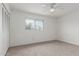 A bright bedroom includes carpet flooring, a ceiling fan, and a window at 1515 N Saguaro Dr, Tempe, AZ 85288