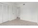 An empty bedroom offers neutral carpet, white walls and a large closet at 1515 N Saguaro Dr, Tempe, AZ 85288