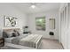 This staged bedroom features neutral decor, a large window, and carpet flooring at 1515 N Saguaro Dr, Tempe, AZ 85288