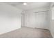 An empty bedroom features white walls, neutral carpet, and a closet at 1515 N Saguaro Dr, Tempe, AZ 85288
