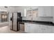 Bright kitchen with stainless steel appliances, double sinks, and white cabinets at 1515 N Saguaro Dr, Tempe, AZ 85288