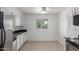Kitchen nook with tiled flooring, stainless steel appliances and window with security bars at 1515 N Saguaro Dr, Tempe, AZ 85288