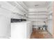 A convenient laundry room offers a washer, dryer and shelving at 1515 N Saguaro Dr, Tempe, AZ 85288