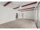 Large living room with exposed beams and access to the kitchen at 1515 N Saguaro Dr, Tempe, AZ 85288